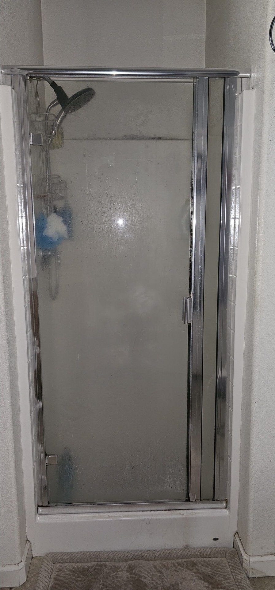 Before: Glass shower door enclosure with foggy steamed glass panel
