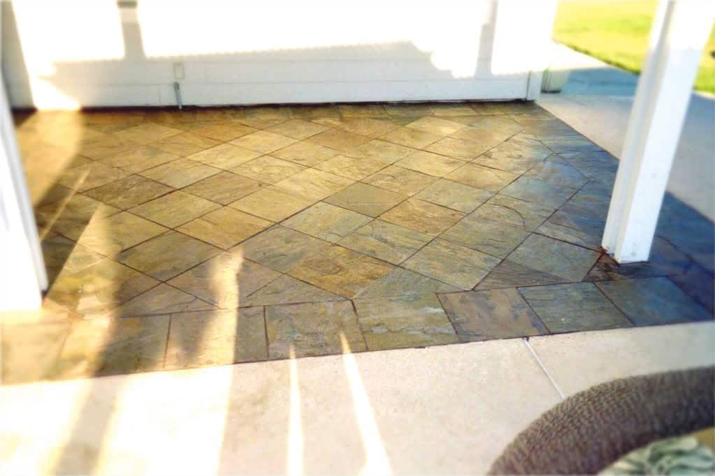 Diagonal slate tile patio floor under covered porch